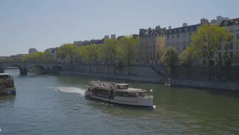 Tourist Boat Going Under Bridge In Quais De Seine Area Of Paris France