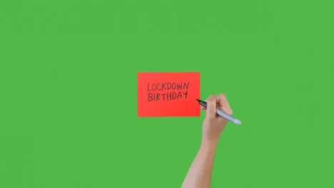 Woman Writing Lockdown Birthday on Paper with Green Screen