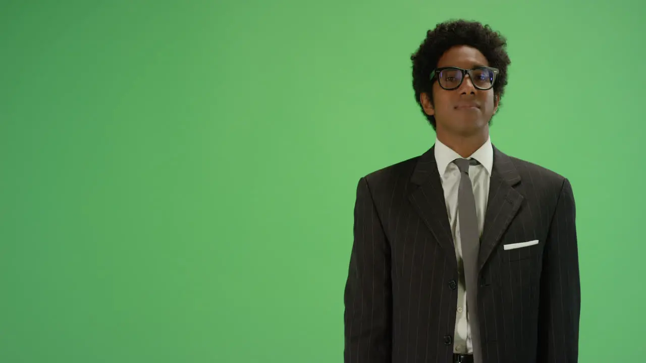 Businessman gesturing with one arm on green screen