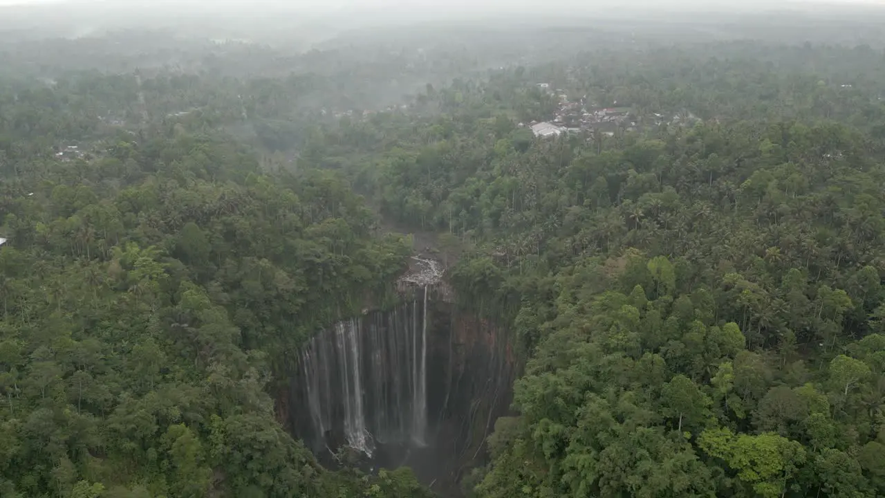 Aerial view of misty jungle waterfall Tumpak Sewu in Java Indonesia