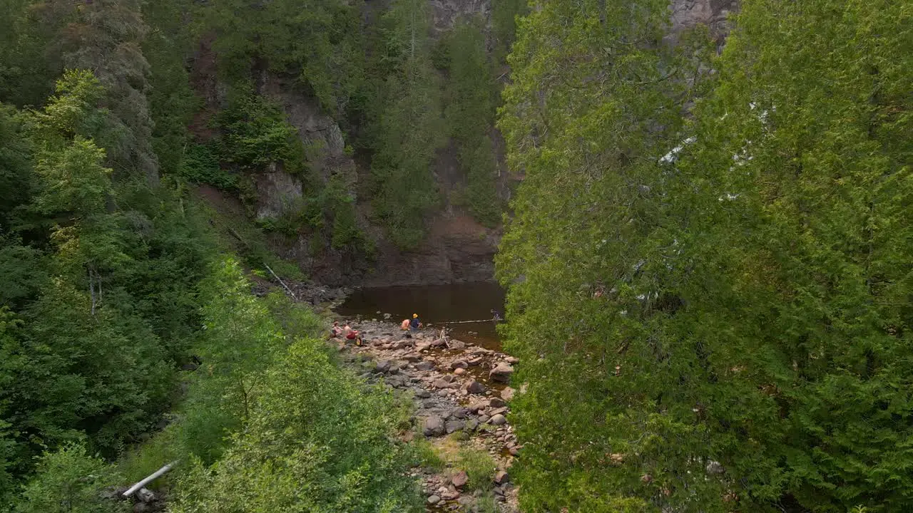 Beautiful hidden waterfall in North Minnesota with people visiting it summer vacation places to go