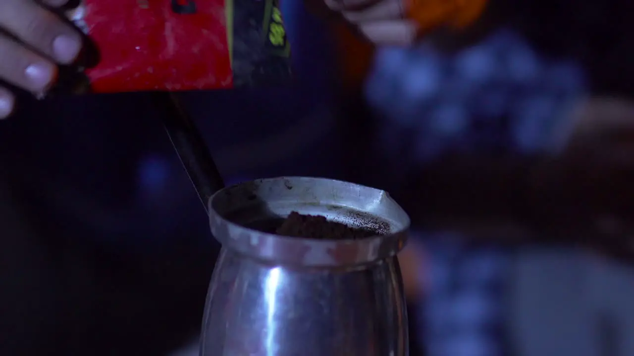 Close up pours coffee into the pot And then mix the coffee with a plastic spoon