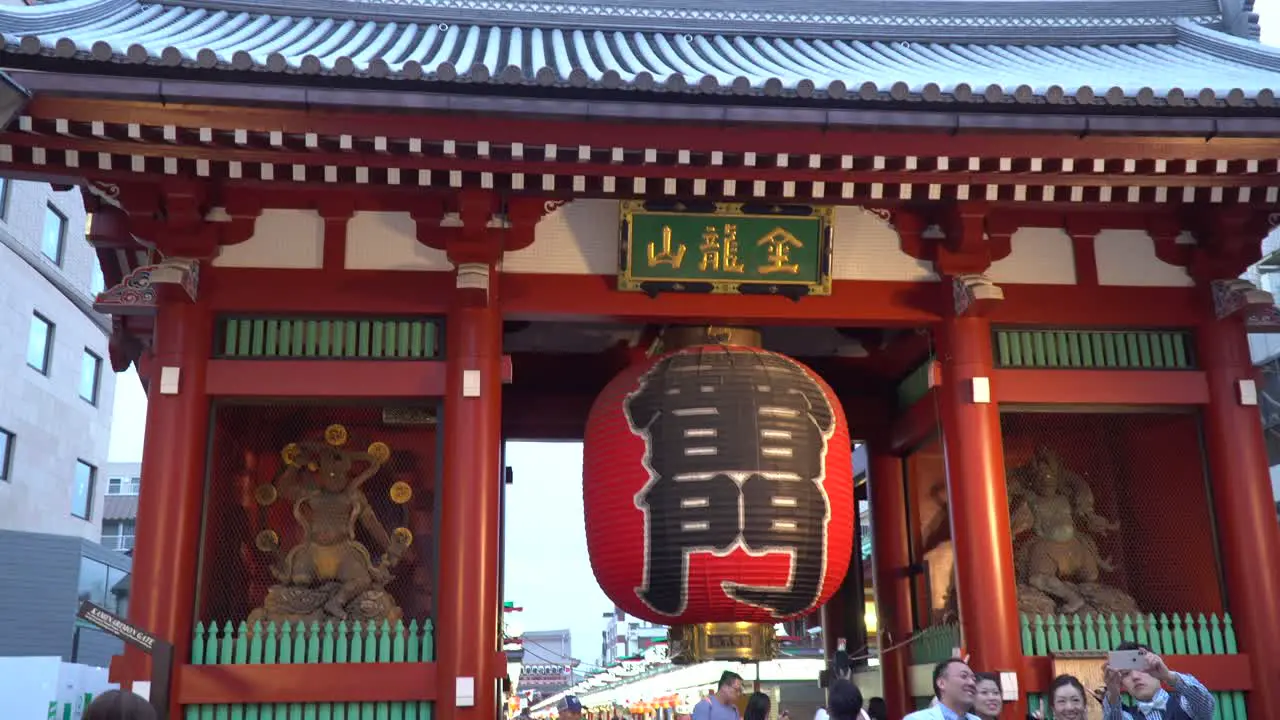 Tourists taking selfies with the Kaminarimon Gate of the Asakusa Shinto Shrine Temple Senso-Ji