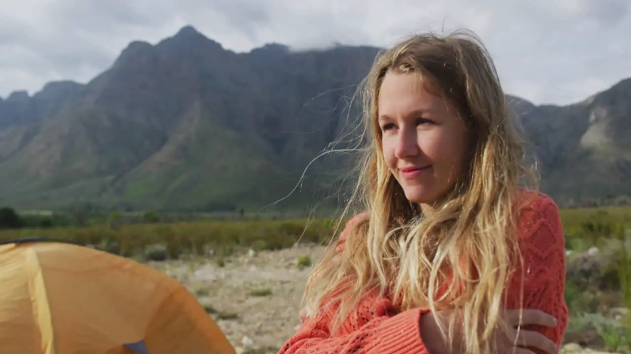 Caucasian woman having a good time on a trip to the mountains looking away and smiling 