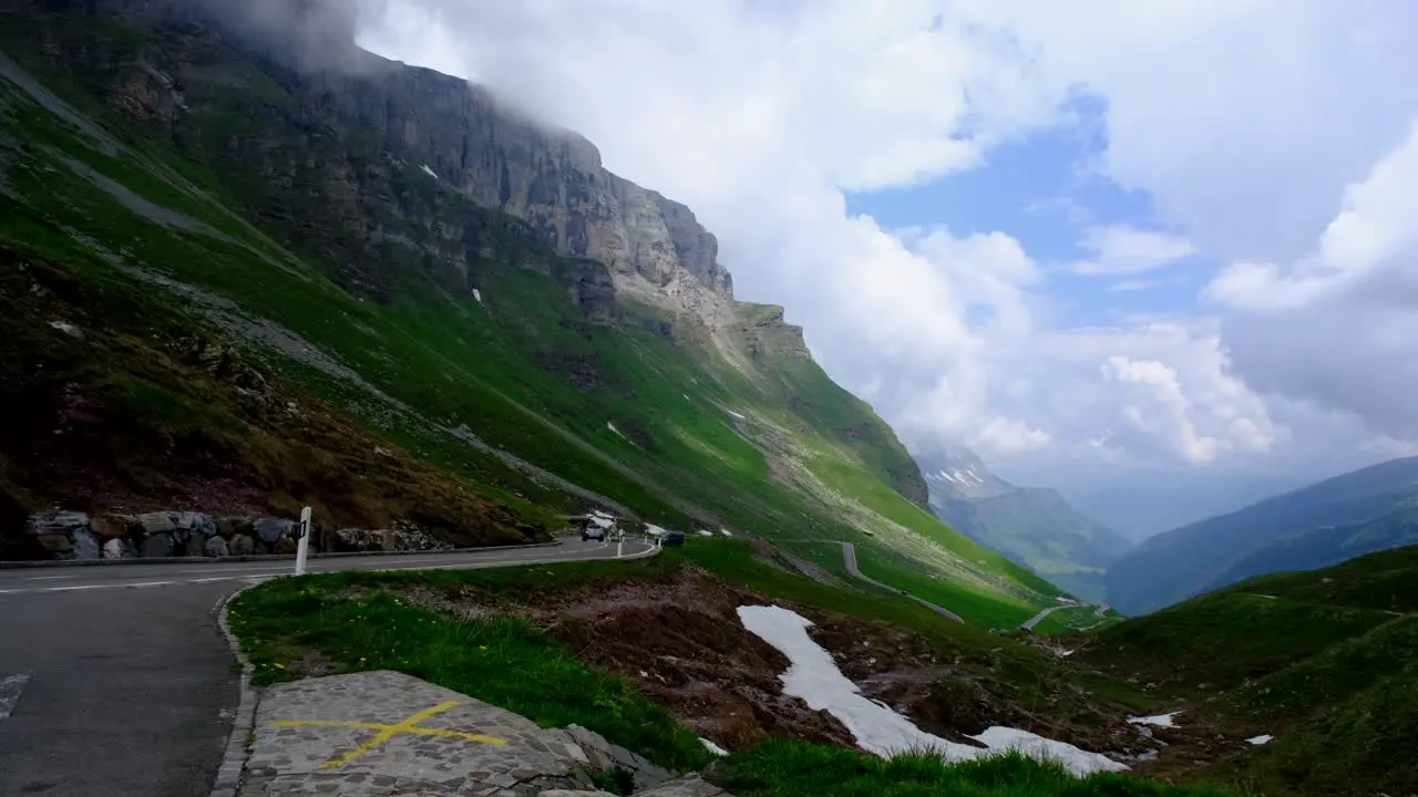 Vehicles run on the road with beautiful landscapes in between