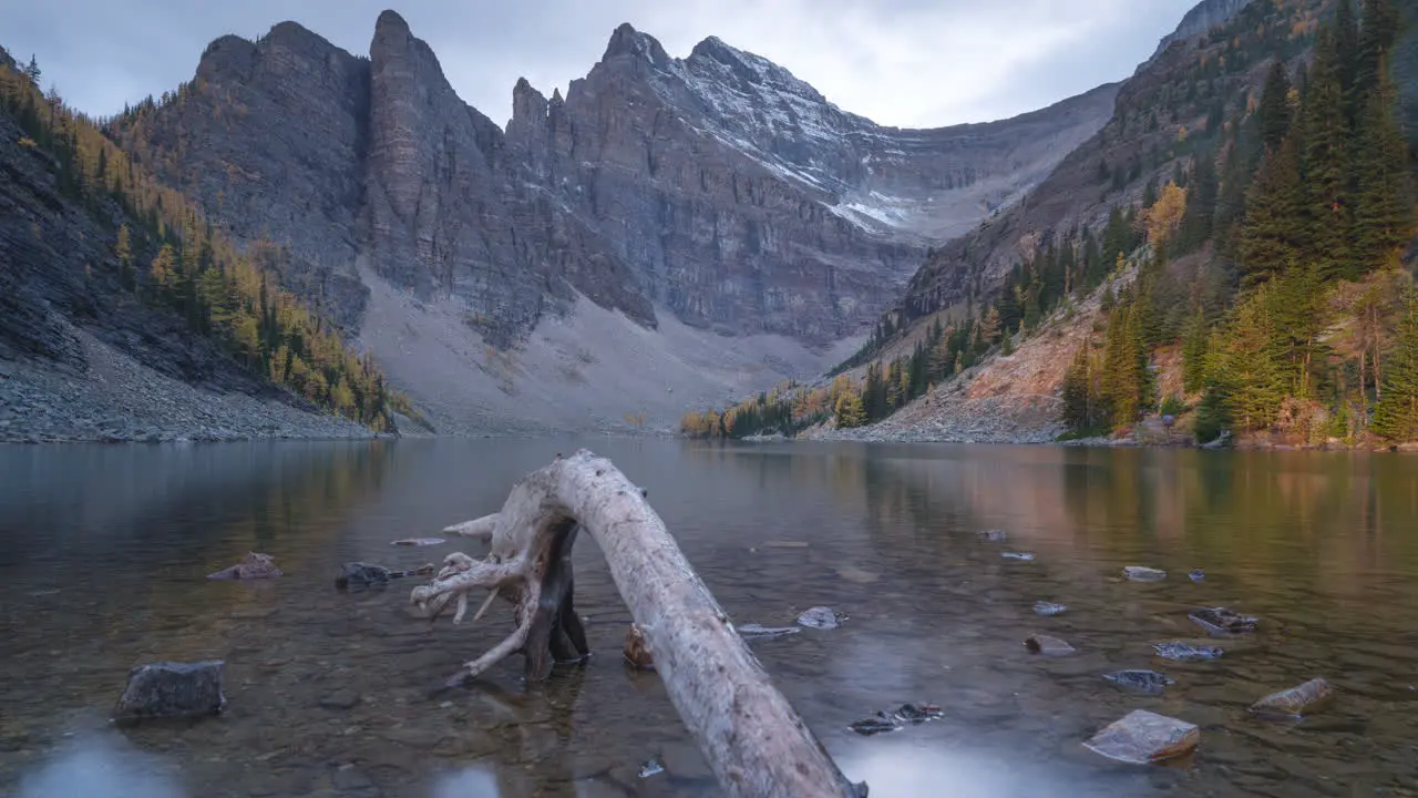 Tranquil lake reflects mountain range in stunning panoramic landscape at Canadian Rockies