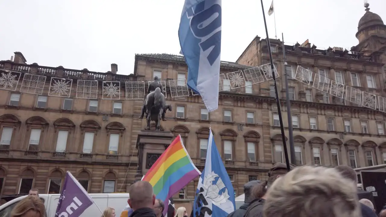 A crowd shot of people with flags in the background at an Scottish Independence rally at George Square