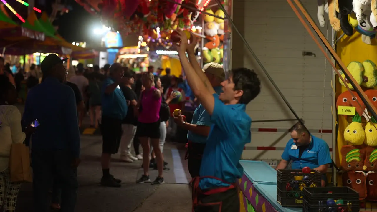 Vendors try to entice people to play carnival games at the CNE