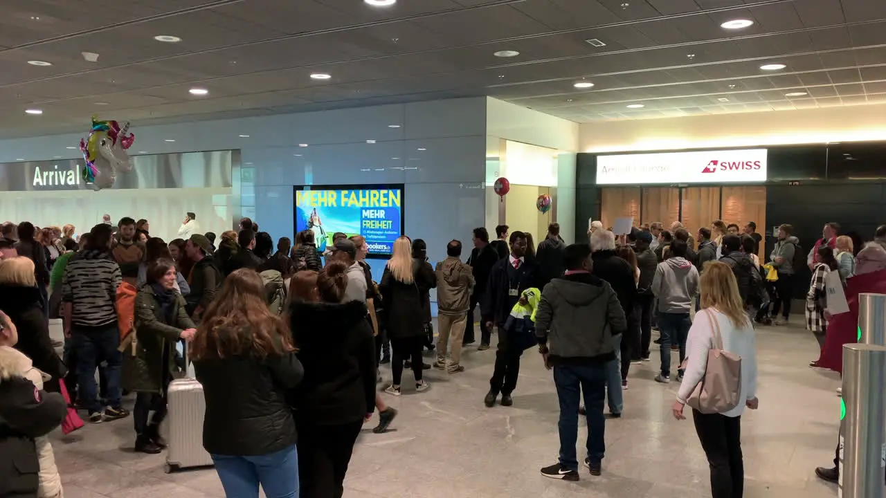 A lot of people are waiting at the airport for their family and friends