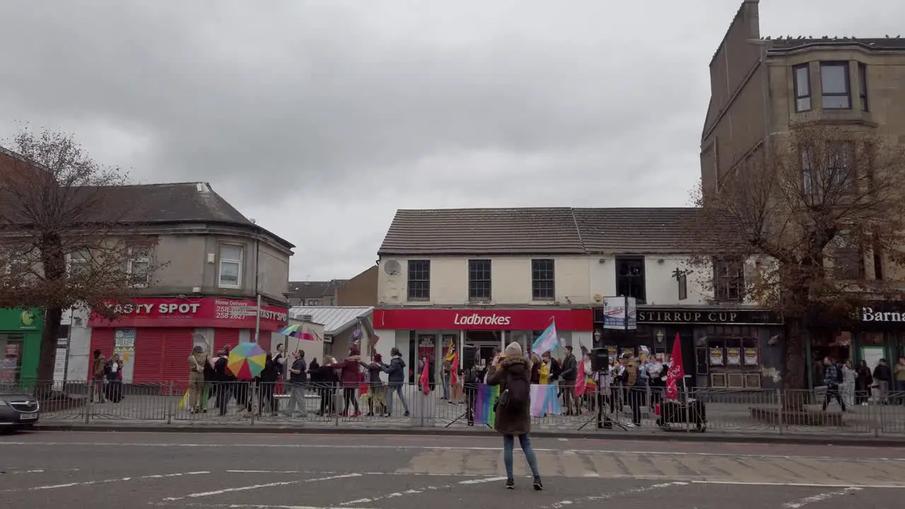 A photographer taking photos of Pro-trans supporters doing the Conga in Rutherglen