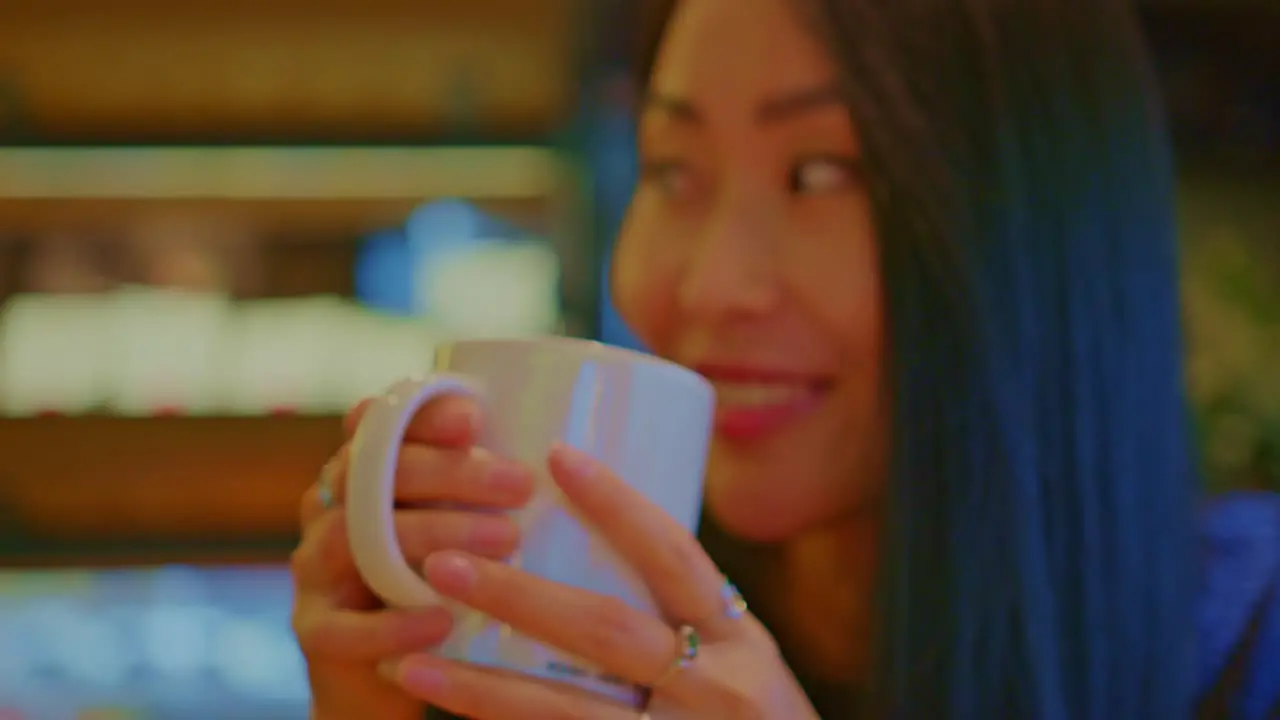 beautiful Asian oriental female girl woman model in cafe restraurant with a cup of beverage drinking talks chats dialogue conversation