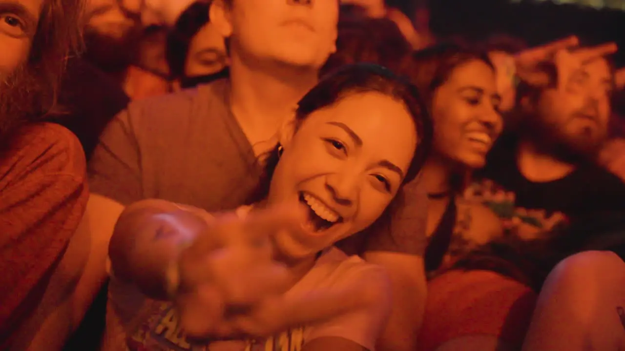 Beautiful Teen Girl In Flashing Lights Making Hip-hop Hand Gesture While Watching Live Concert At Night In Toronto Canada