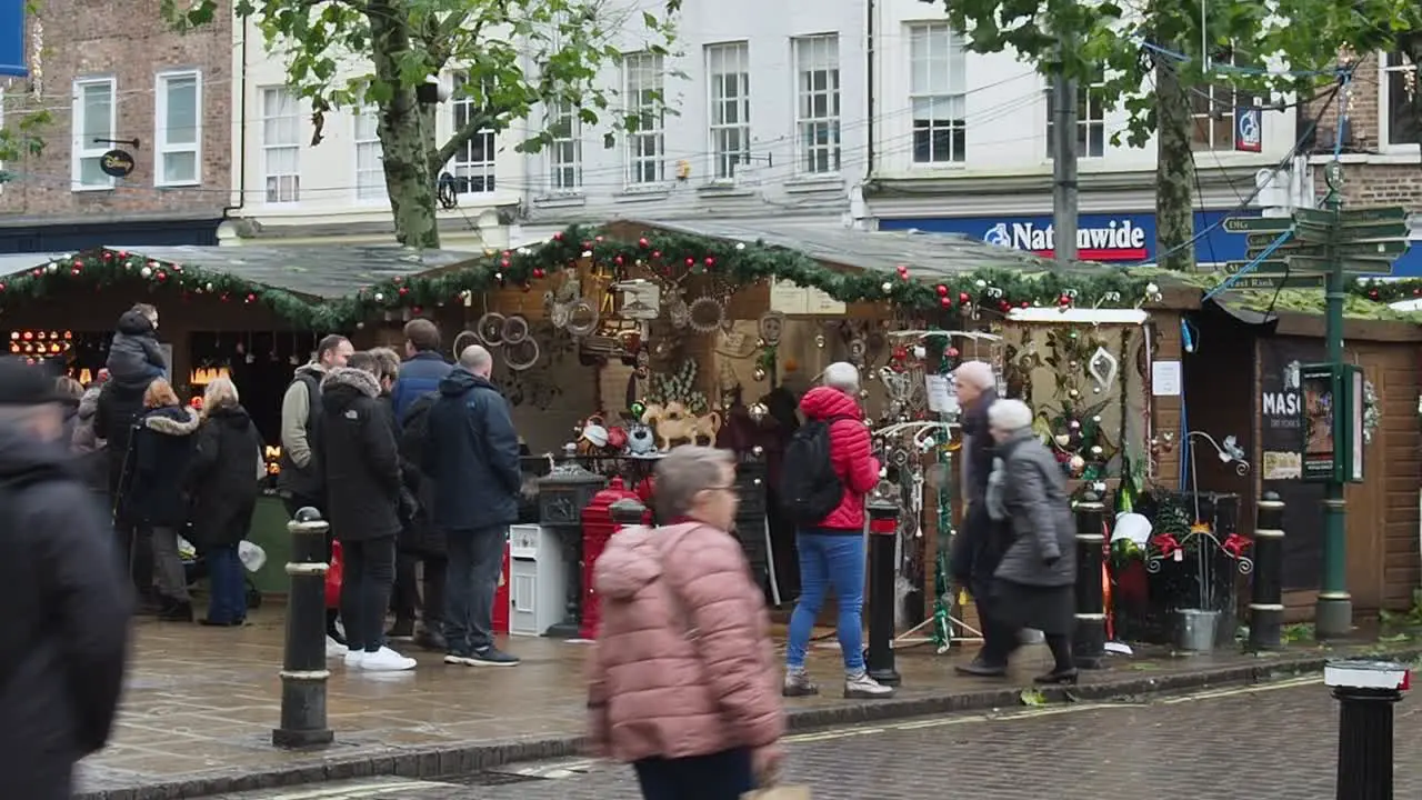 Busy Christmas shoppers at a Christmas market in the medieval town of York England UK