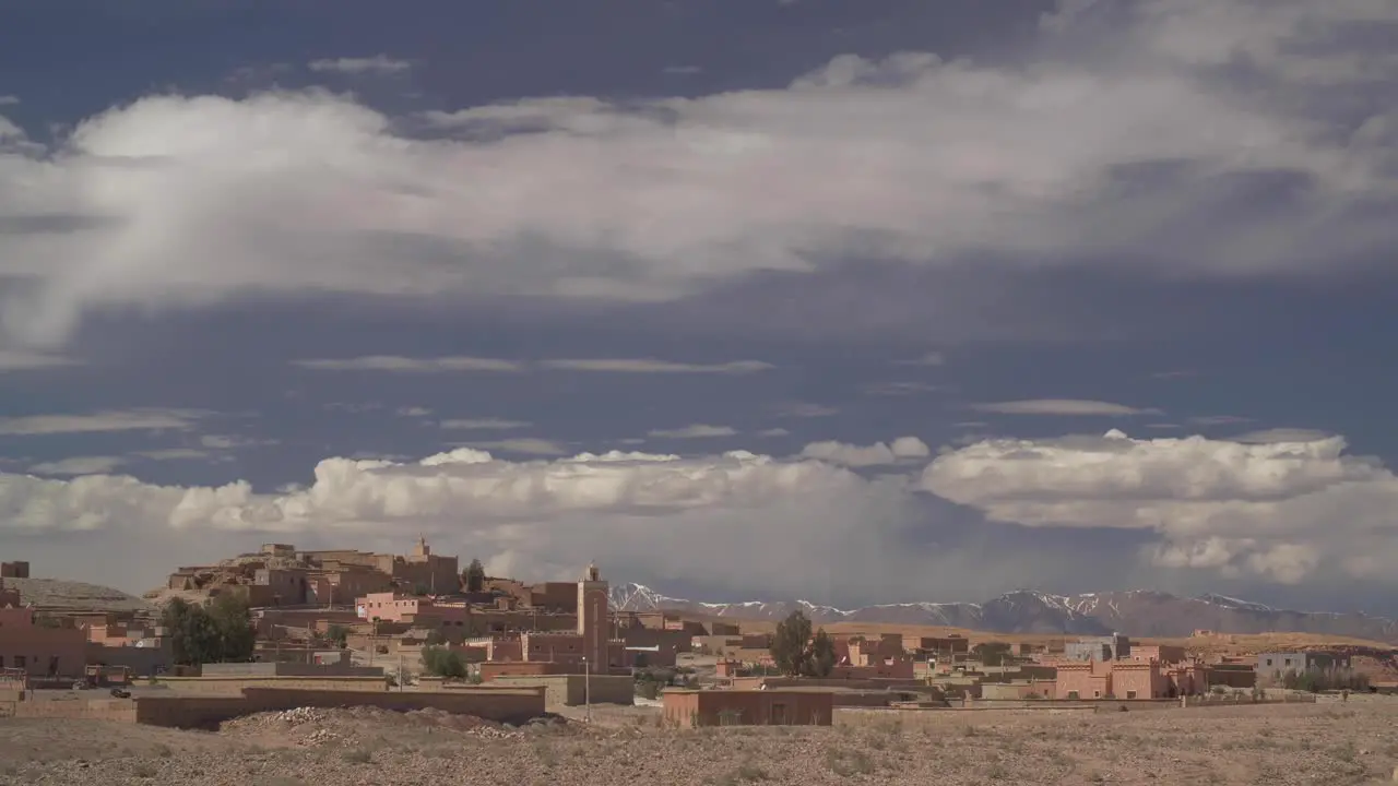 view on a small village in the south of Morocco with snowing mountains