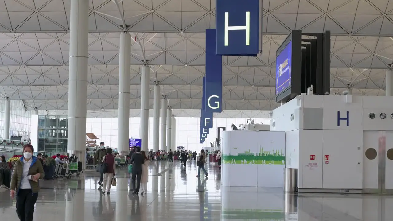 Travel passengers are seen at the airline check-in hall in Hong Kong's Chek Lap Kok International Airport