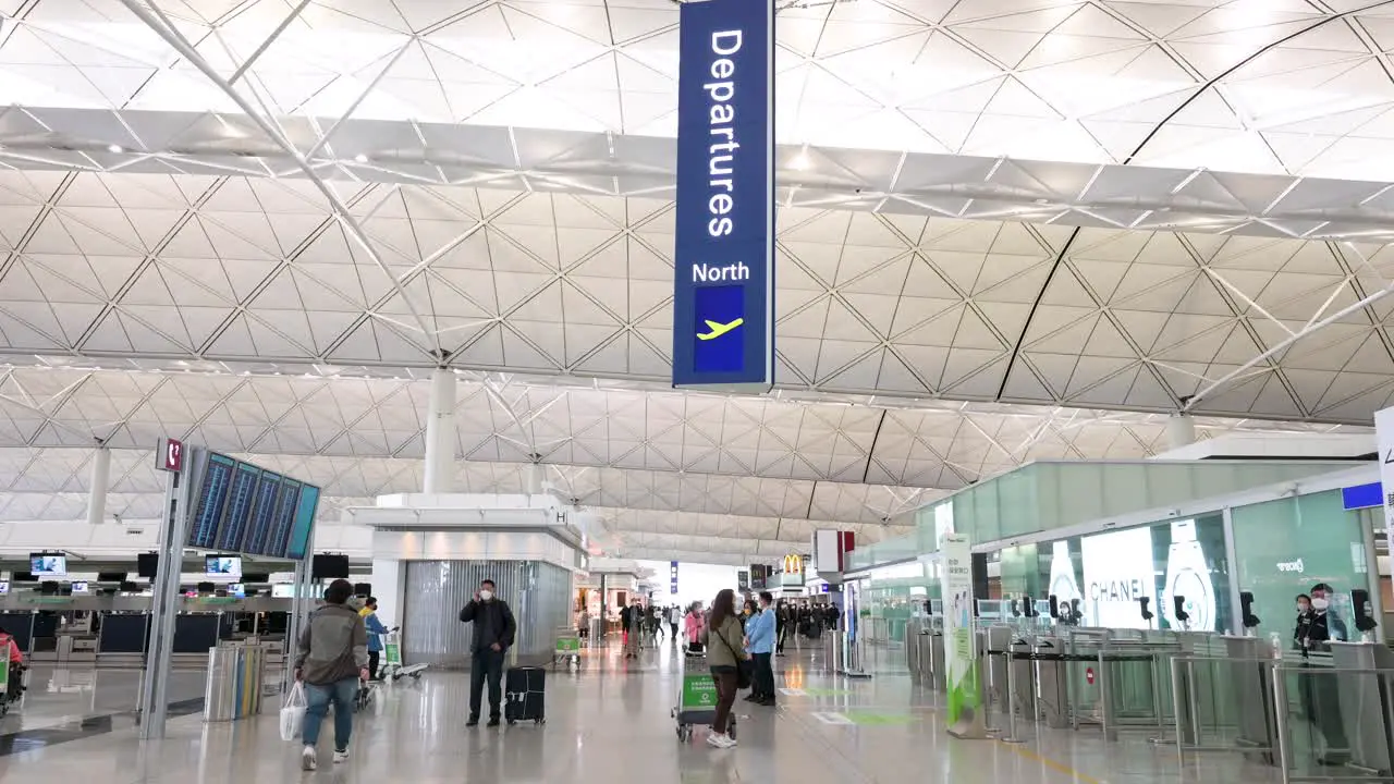 Travel flight passengers are seen at the departure hall as they go through the security check at Hong Kong international airport