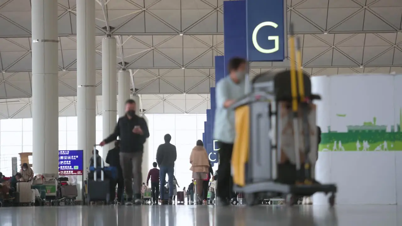 Travel passengers walk towards the airline check-in desks located at the departure hall in Hong Kong's Chek Lap Kok International Airport