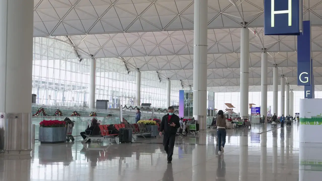 Travel Chinese passengers walk towards the airline check-in desks located at the departure hall in Hong Kong's Chek Lap Kok International Airport