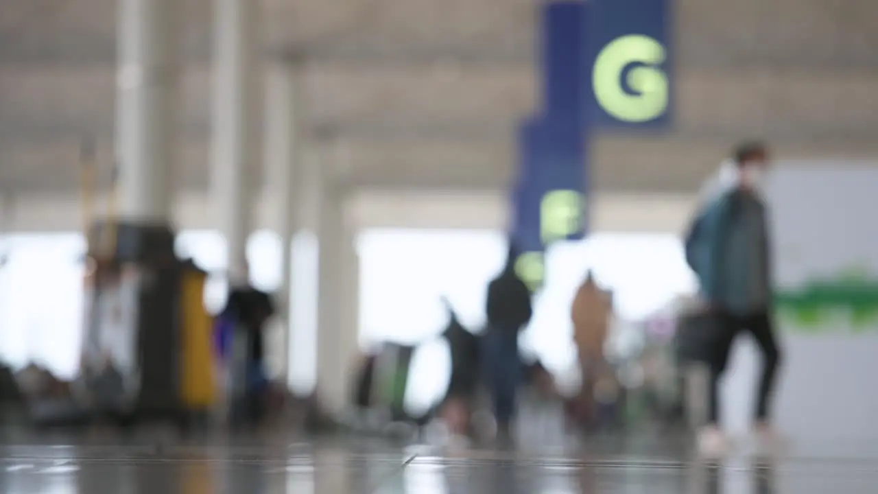 Out of focus view of an travel airline check-in hall as passengers walk through in Hong Kong's Chek Lap Kok International Airport