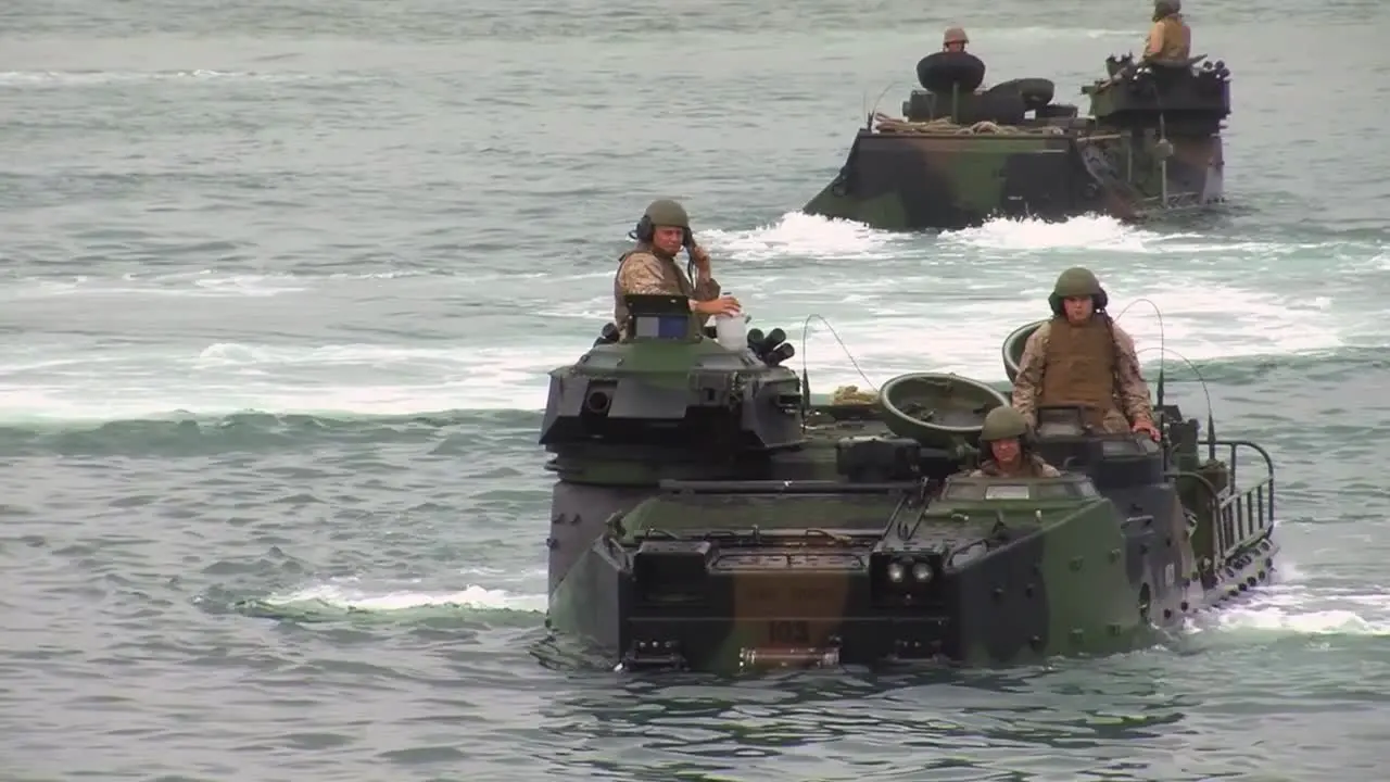 Amphibious Armored Assault Vehicles Are Driven Across A Bay And Onto A Ship 3