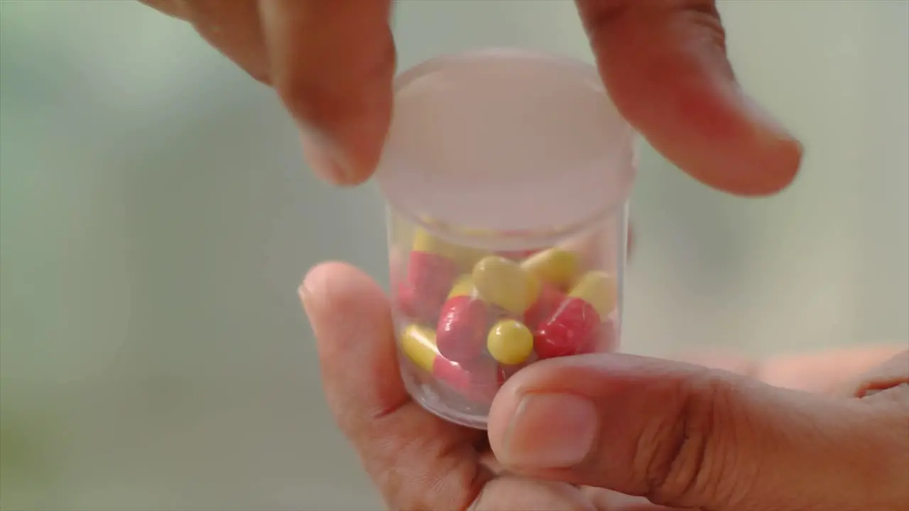 close up of the hand covering the drug capsule