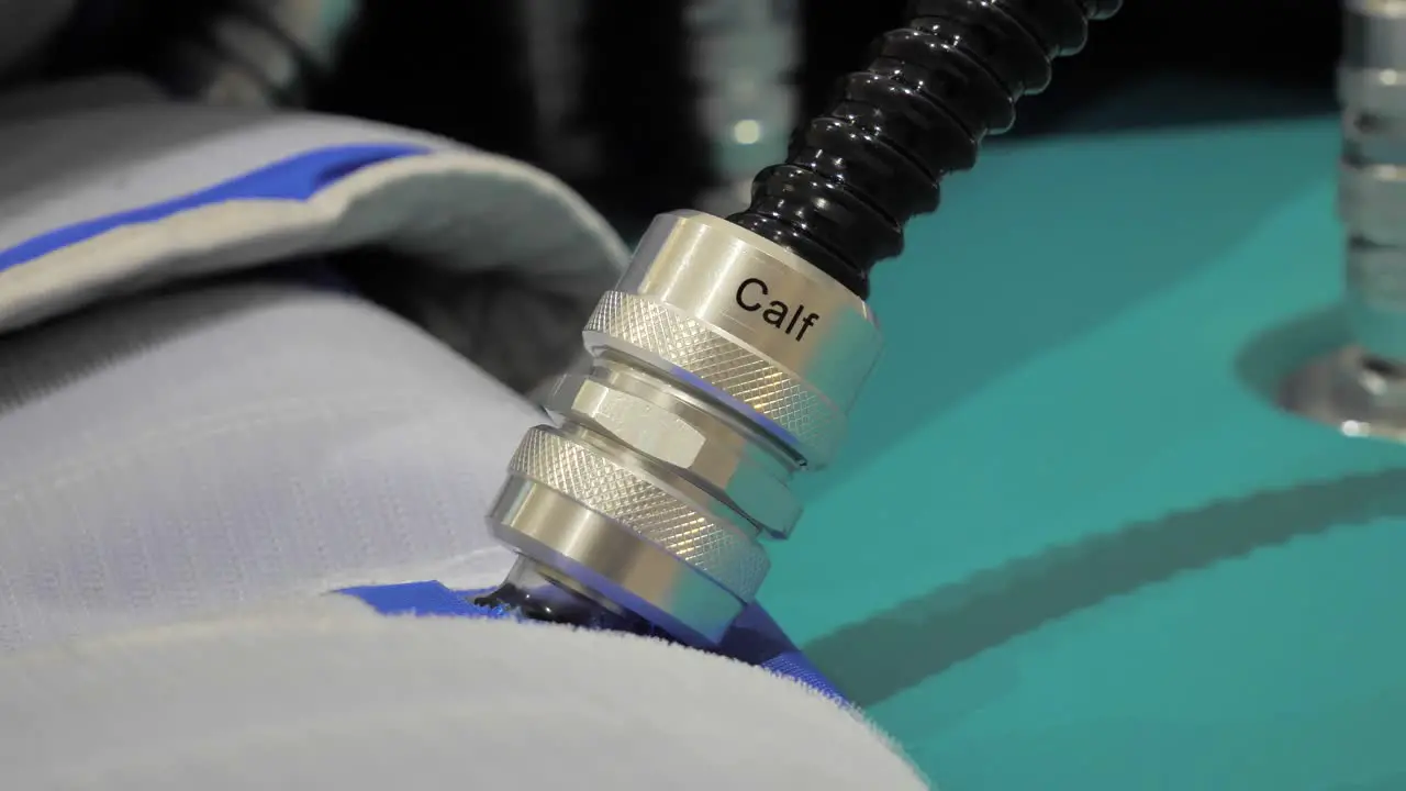 Slow motion shot of pump connectors connected to a patient's calf for heart problems