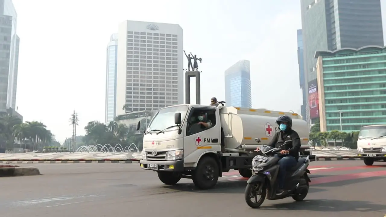 a disinfectant spray car to eliminate the covid 19 virus crosses the heart of the capital city of Jakarta to be precise at the Monas horse statue monument