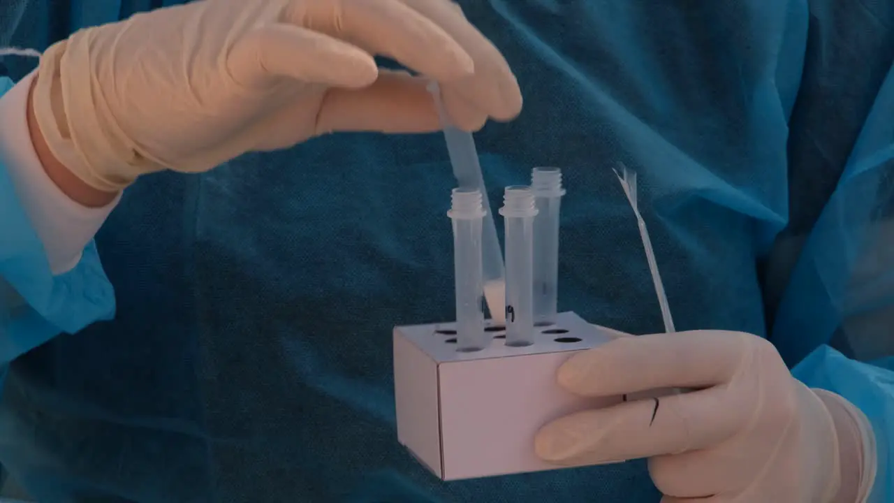 A healthcare worker prepares vials for the new COVID-19 rapid testing