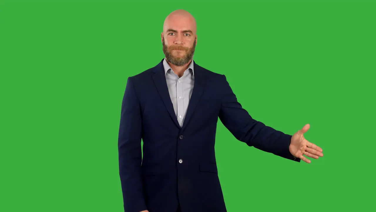 A man revealing something on screen as he is presenting on green screen