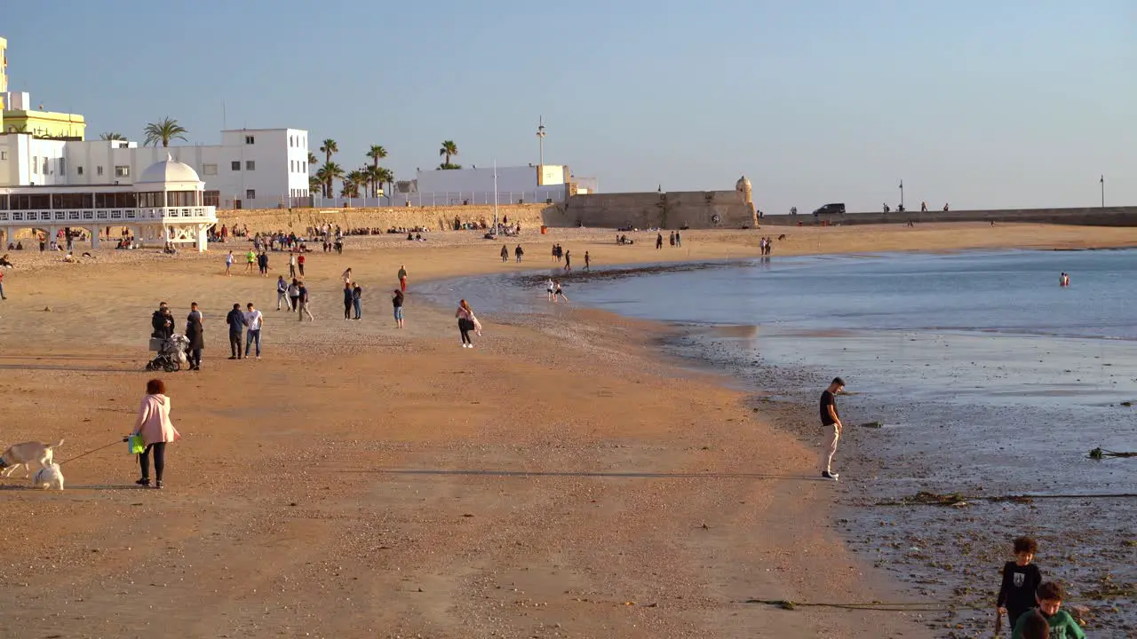 Beautiful Mediterranean beach with people in early spring