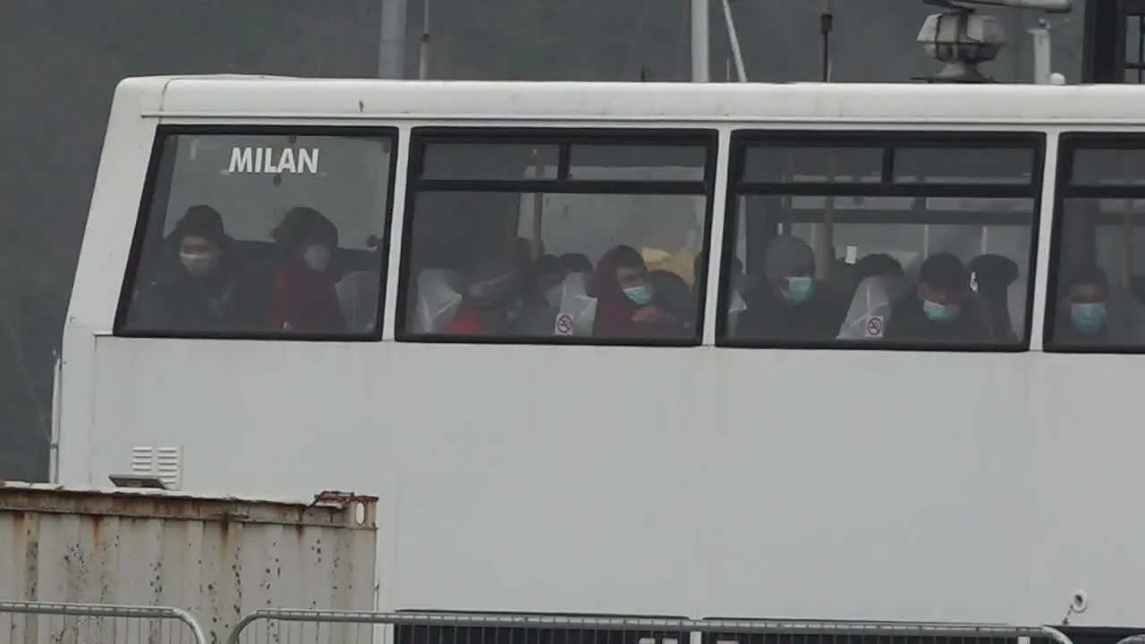 Migrants wait in a bus to be taken to a processing centre in the port of Dover UK