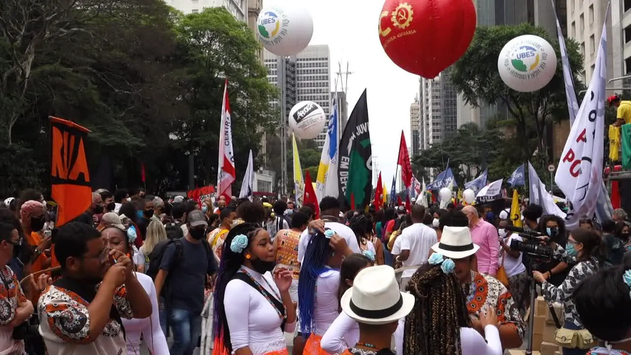 masked protesters on rally against brazilian president in Paulista avenue OUT Bolsonaro