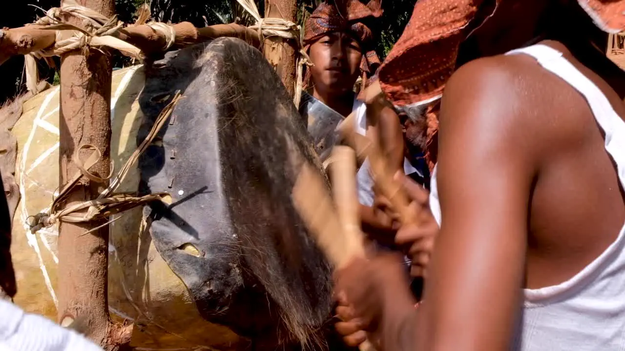 Timorese youth drumming on a homemade cowhide drum at traditional cultural welcome ceremony at remote village in Timor Leste Southeast Asia closeup of boys drumming