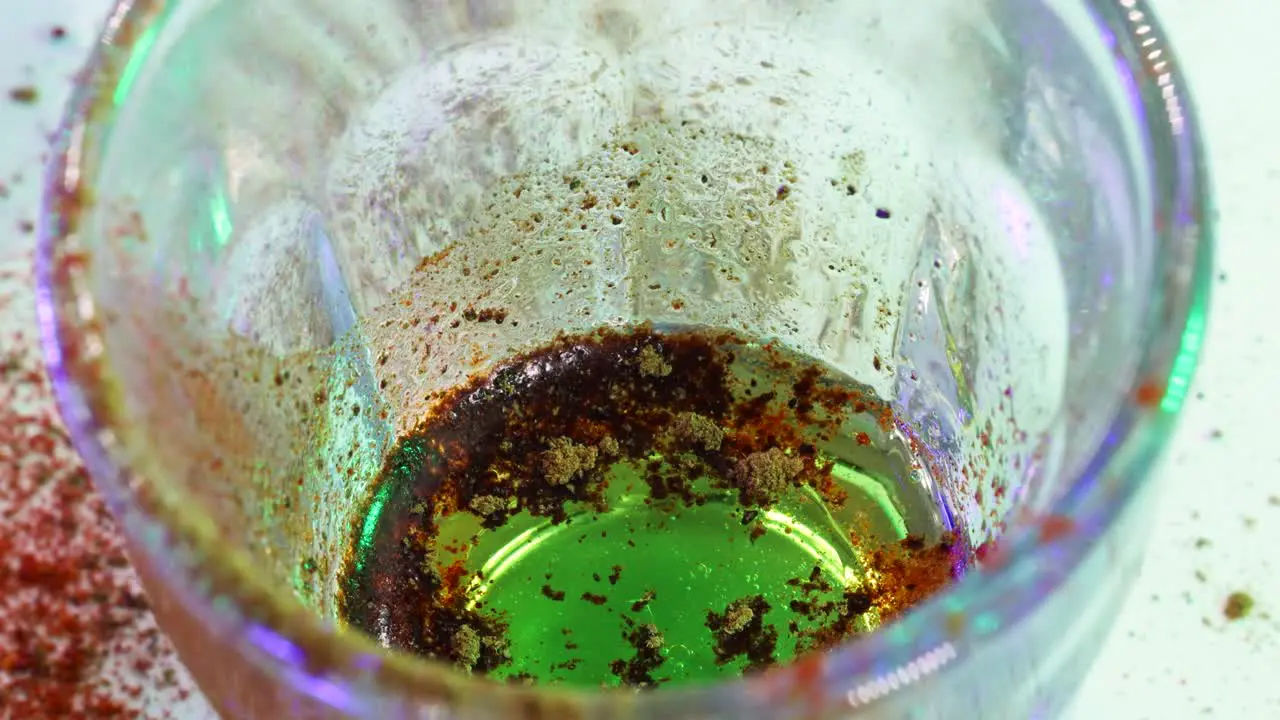 Macro shot of golden powder turning black with chemical reaction