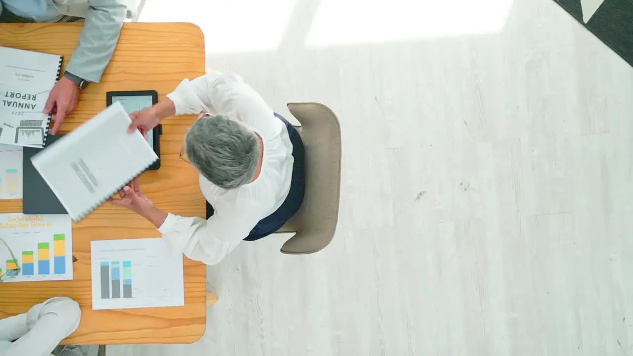 Business people tablet and analytics on table