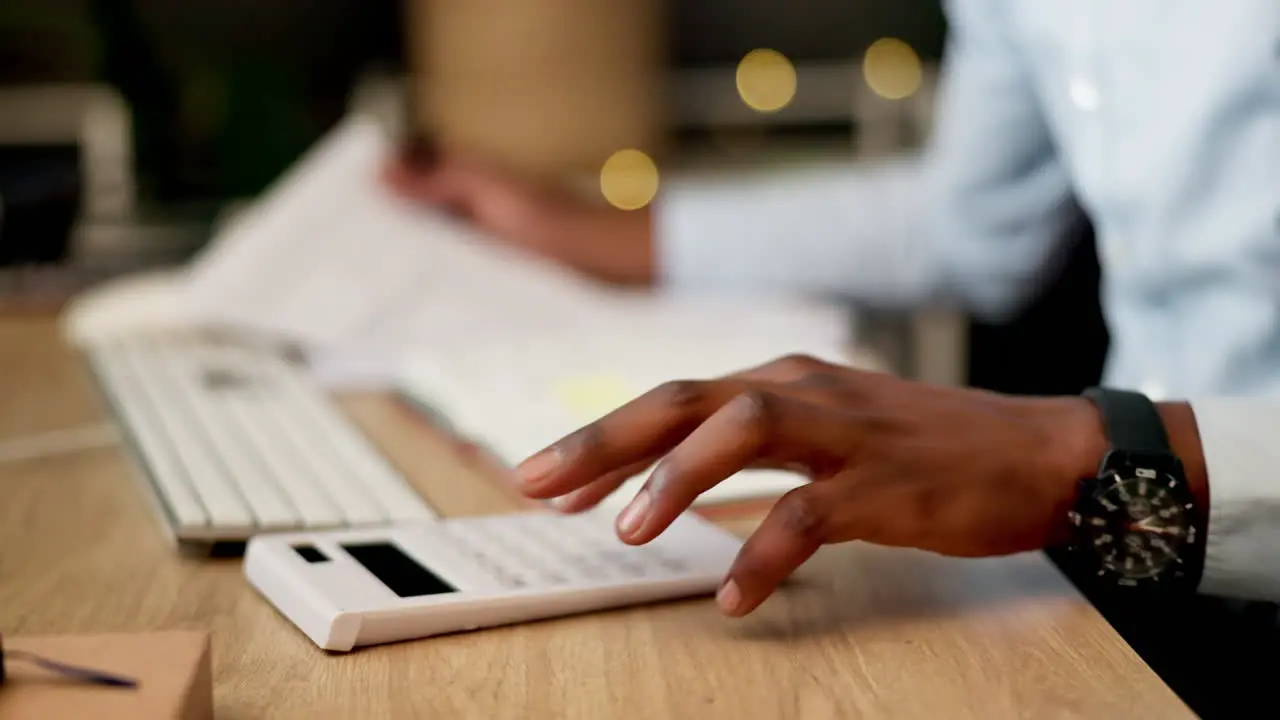 Businessman hands and calculator at night