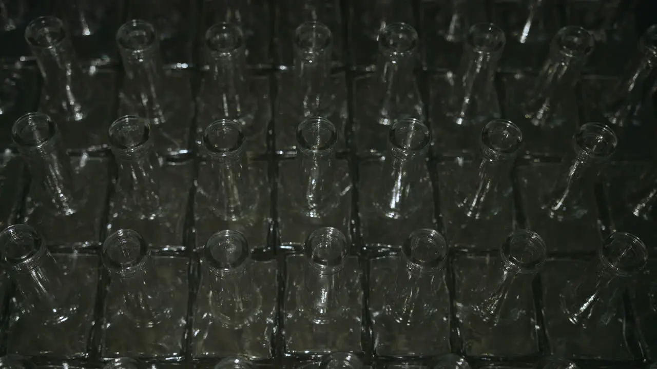 Static Shot Of Empty Liquor Bottles Being Hit By Panning Light