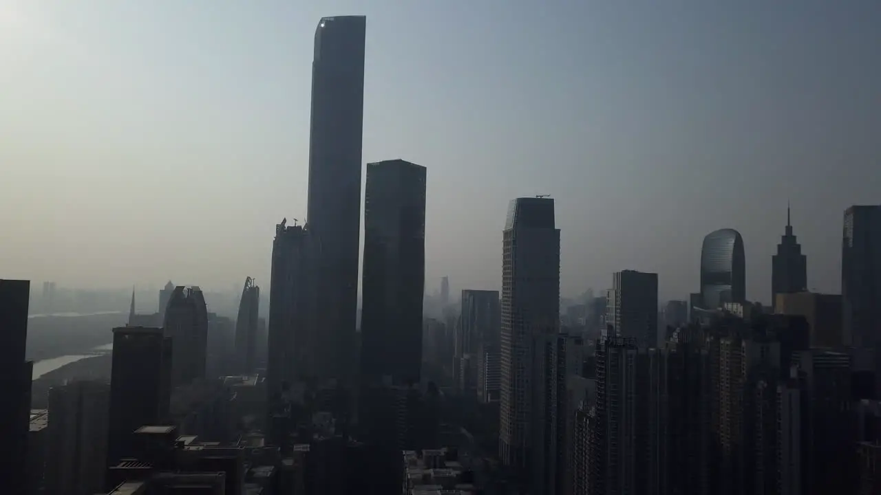 Aerial shot of mega city Guangzhou Central building district with office building skyscrapers on a sunny day in the afternoon