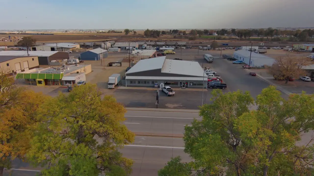 An industrial park in a rural community establishing shot with drop into trees