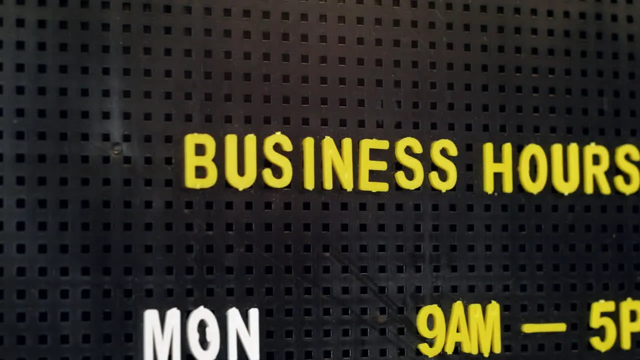 Business opening hours on a retro pin board sign