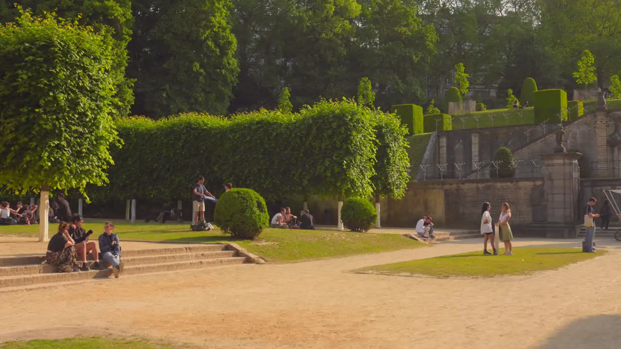 Shot of garden of college students sitting in Cumbre Abbey  covered with green vegetation in Brussels Belgium on a sunny day