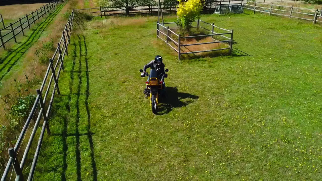 Older Man on Motorcycle on Green Field on a Canadian Farm