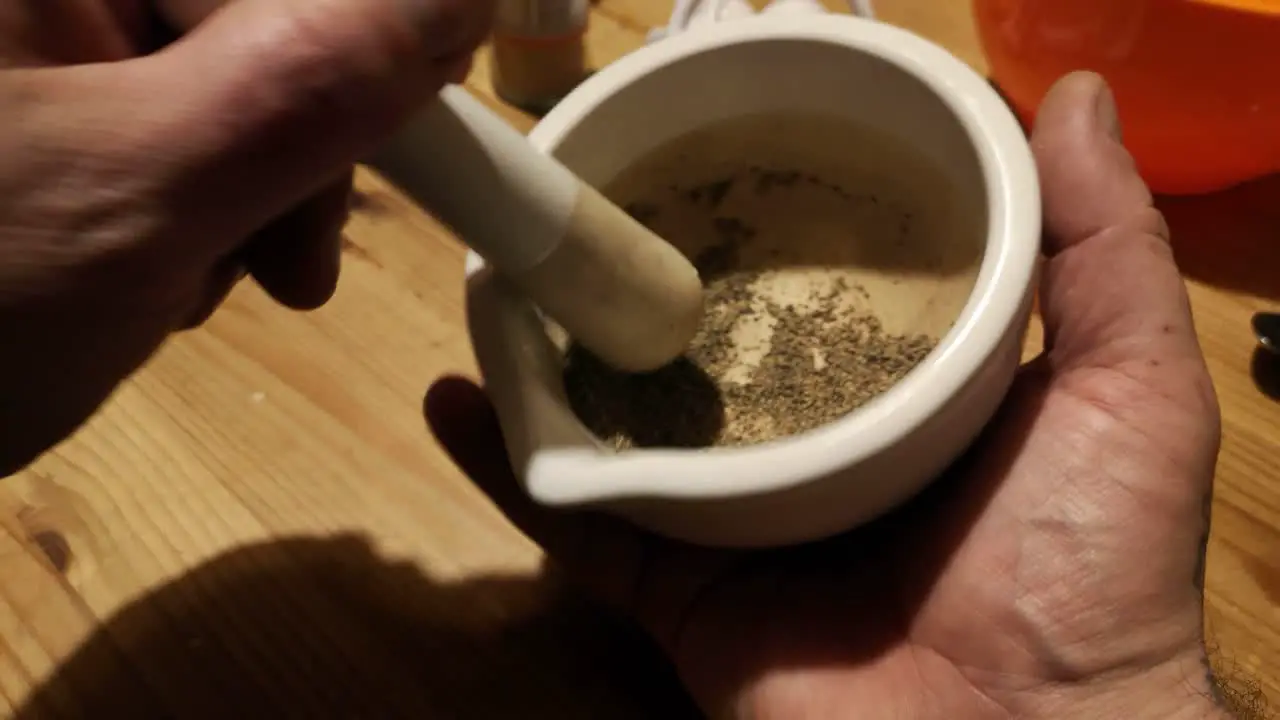 Grinding black pepper powder herbal remedy supplement with mortar and pestle