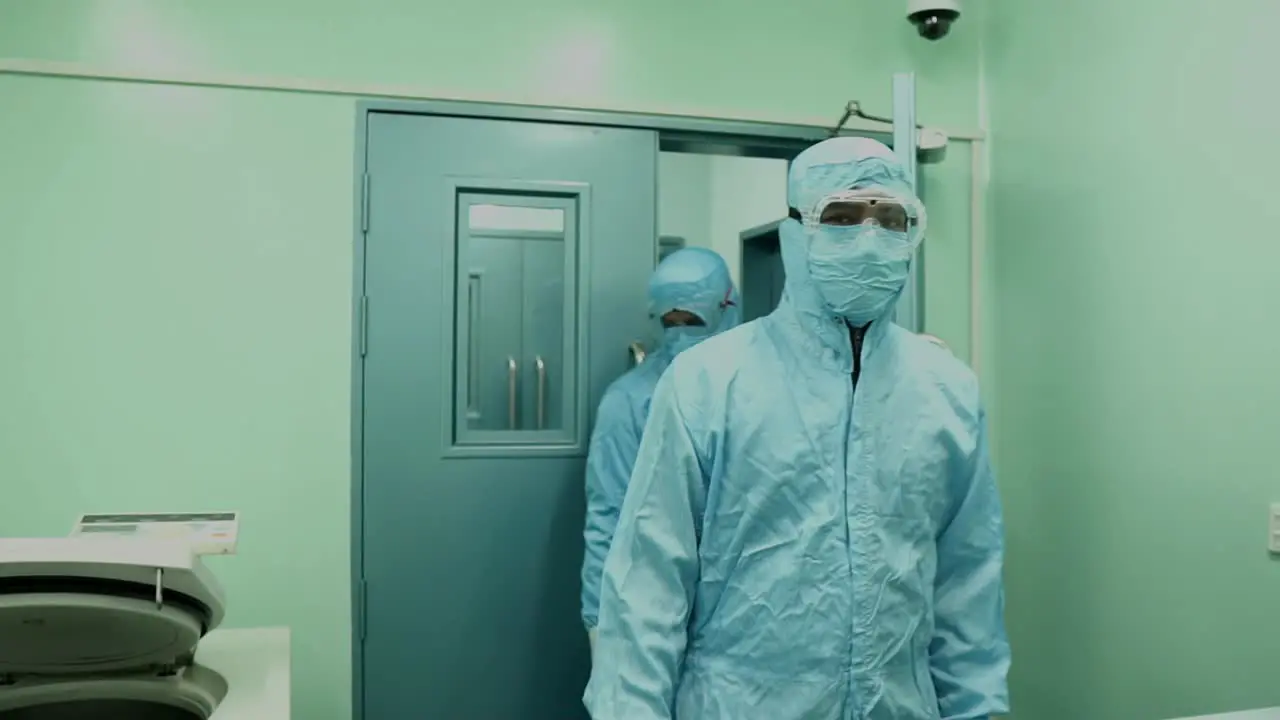 Health Workers In Full PPE Walking Through Door In Karachi Hospital