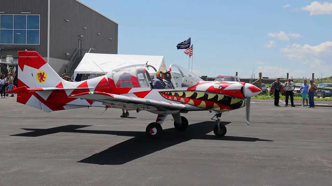 Scottish Aviation SK 61 Bulldog with unique paint job taxiing in front of a hanger at an airshow at Centennial Airport in Colorado