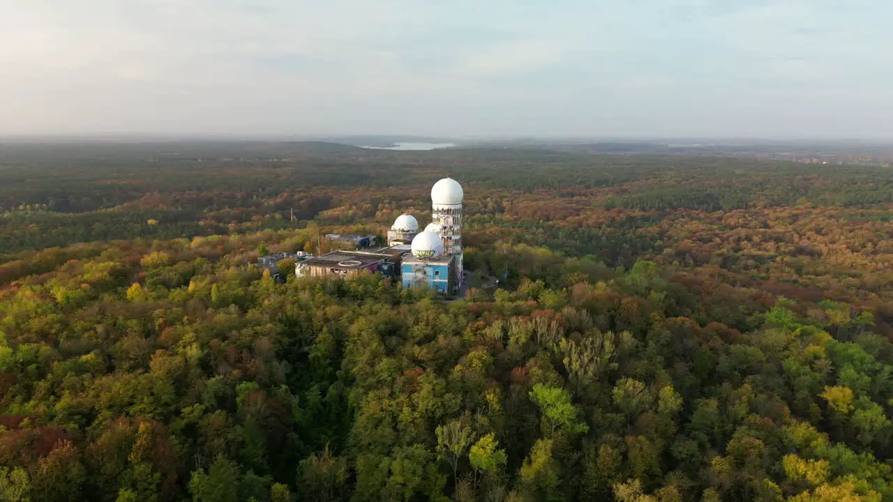 Smooth aerial view flight Architectural ruin in autumn forest at morning sunrise devil's mountain in woods berlin October 2022