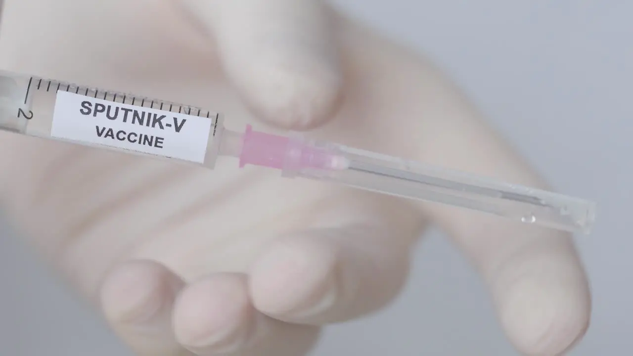 Hand Pull Out The Needle From Syringe With Sputnik-V Vaccine  Close Up Shot