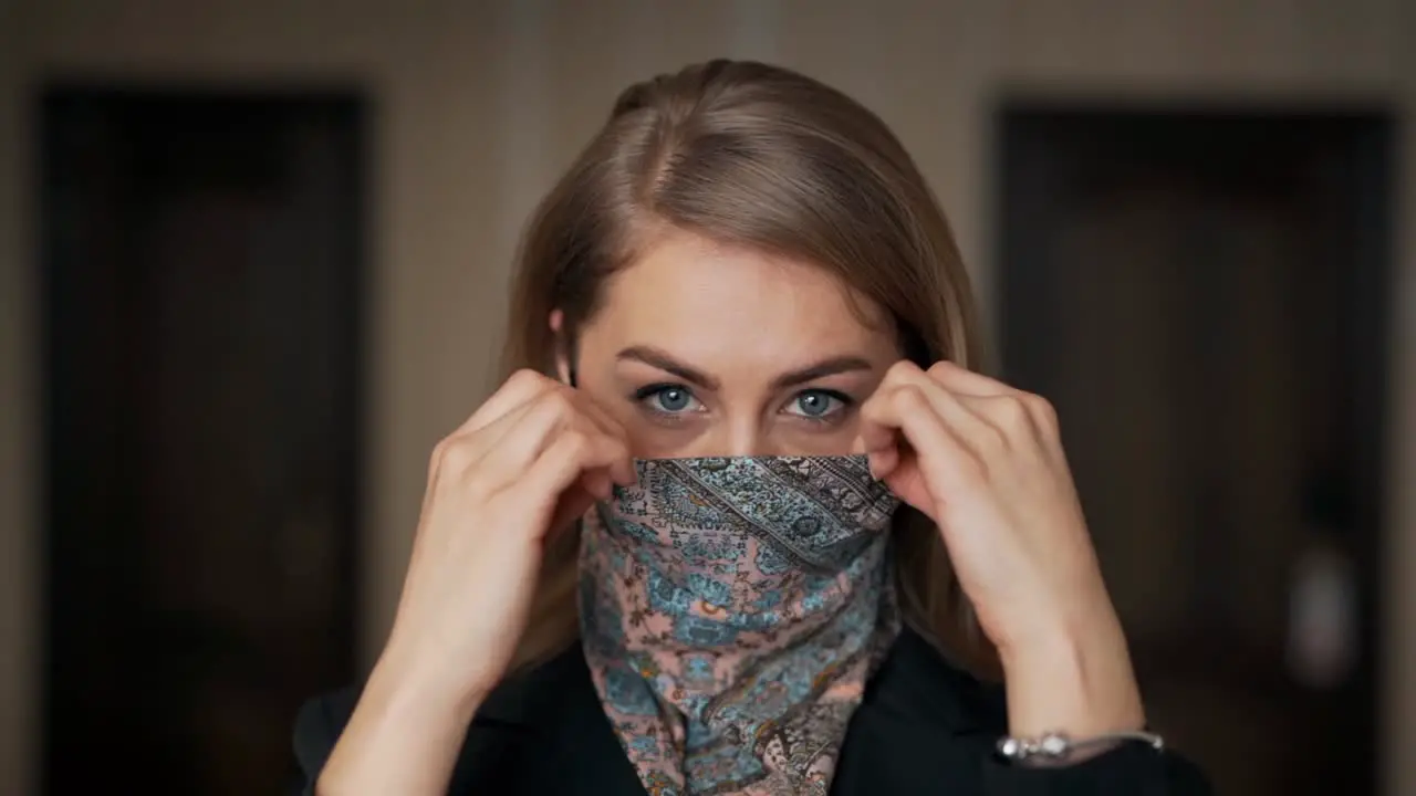 Close-up portrait of a pretty adult girl wearing a protective headscarf mask