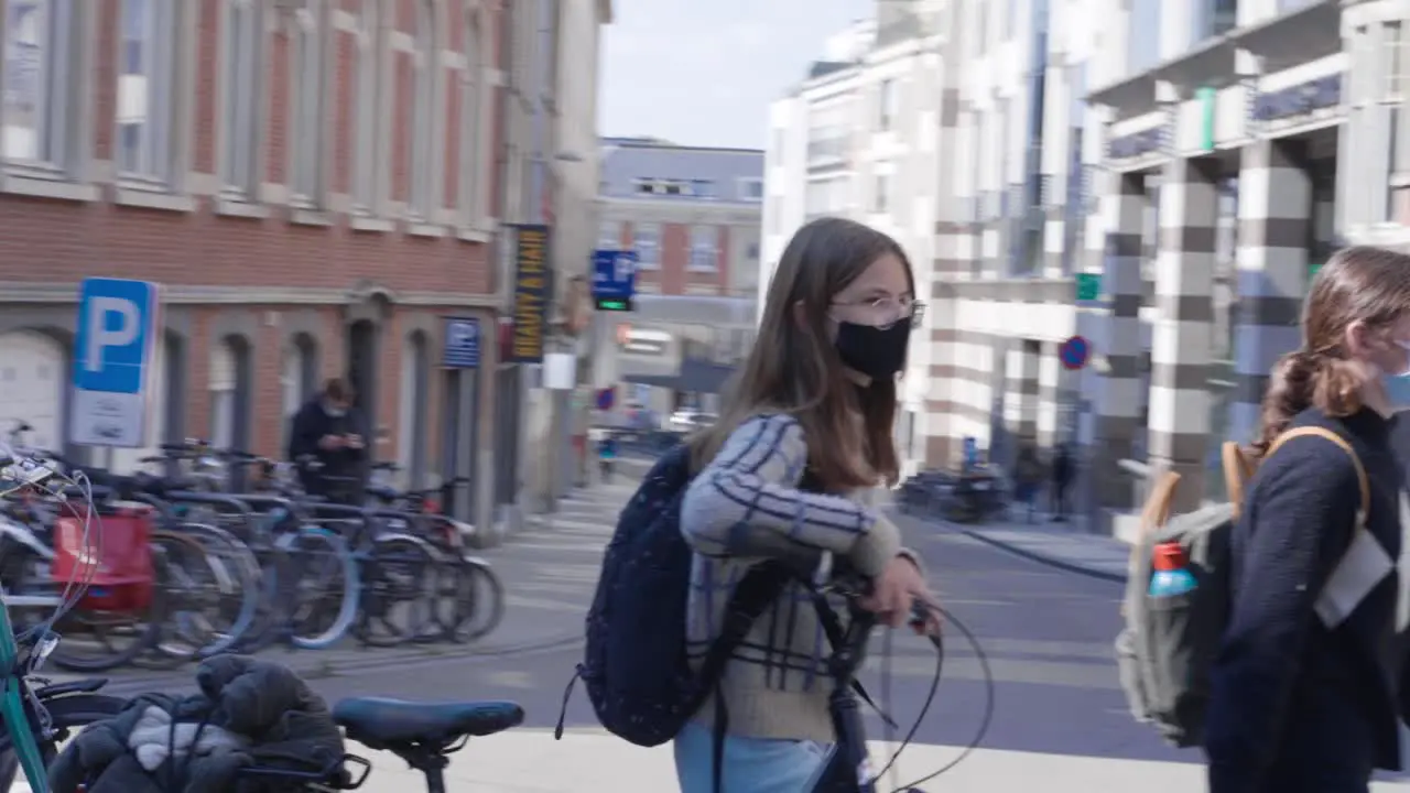 Teenage girl students in medical masks walking down the street close up