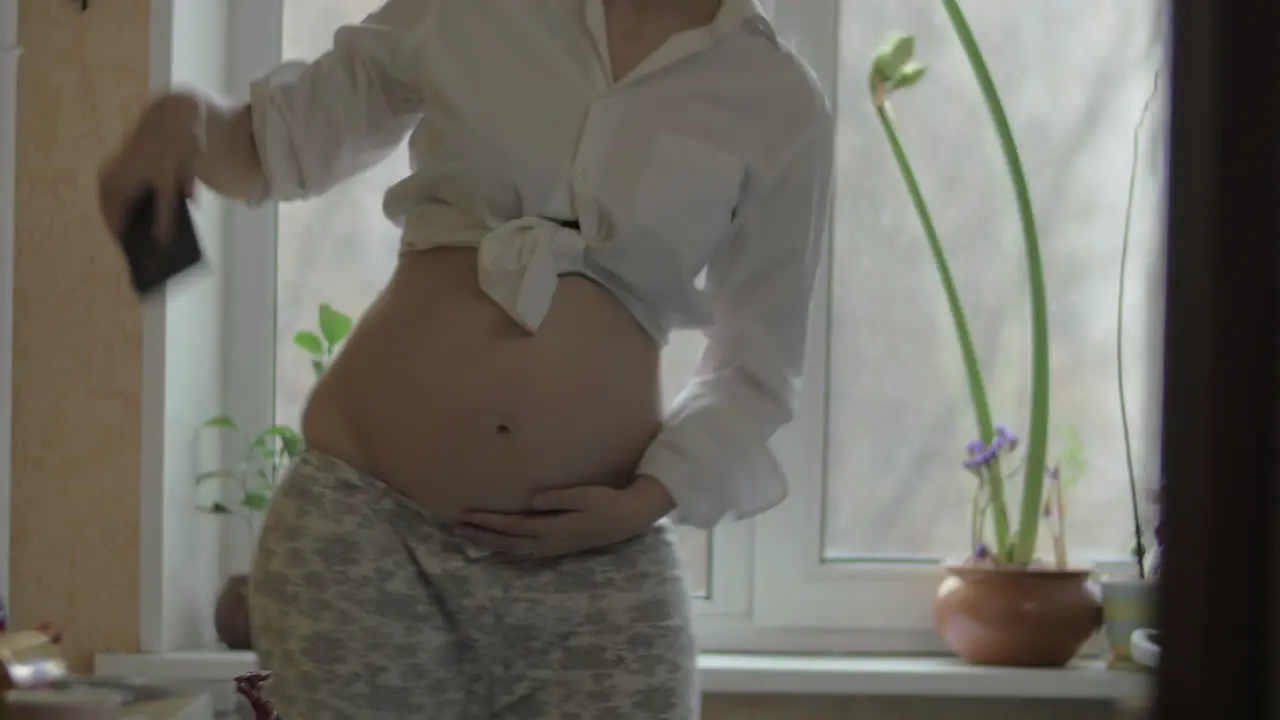 Pregnant woman dancing gracefully at home